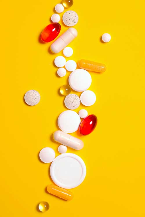 pills and medicine on a yellow background