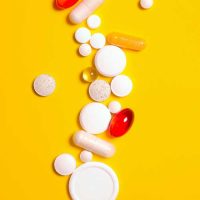 pills and medicine on a yellow background